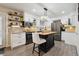 Modern kitchen featuring white cabinets, stainless steel appliances, and a stylish center island at 6948 Buckskin Dr, Littleton, CO 80125