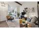 Cozy living room with vaulted ceiling, brick fireplace, stylish decor, and ample natural light at 6948 Buckskin Dr, Littleton, CO 80125