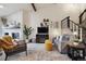 Comfortable living room featuring a cozy fireplace, modern decor, and an adjacent staircase at 6948 Buckskin Dr, Littleton, CO 80125