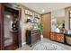 Charming sitting room featuring an antique dresser, accent wall, and a vintage telephone booth at 6948 Buckskin Dr, Littleton, CO 80125