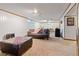Finished basement with carpet flooring, paneled walls, and ample space for recreation and relaxation at 8481 E Briarwood Blvd, Centennial, CO 80112