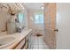 Bathroom featuring a double sink vanity, neutral decor, and shower with curtain at 8481 E Briarwood Blvd, Centennial, CO 80112