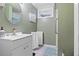 Cozy bathroom featuring a white vanity, tiled floor, and a framed window providing natural light at 8481 E Briarwood Blvd, Centennial, CO 80112