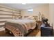 Bedroom in basement with egress window, carpet, and built-in bookcase storage at 8481 E Briarwood Blvd, Centennial, CO 80112