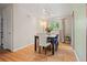 Well-lit dining room with hardwood floors, stylish seating, and a view of the outdoors at 8481 E Briarwood Blvd, Centennial, CO 80112