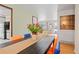 Bright dining area with hardwood floors, modern chairs, and a view of the front yard at 8481 E Briarwood Blvd, Centennial, CO 80112