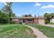 Charming single-story brick home with well-maintained lawn and inviting front entrance at 8481 E Briarwood Blvd, Centennial, CO 80112