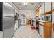 Functional kitchen with stainless steel appliances, white cabinetry, and easy access to the dining area at 8481 E Briarwood Blvd, Centennial, CO 80112