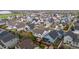 Aerial view of a neighborhood with houses, manicured lawns, and trees in a peaceful community at 4422 Mt Shavano St, Brighton, CO 80601