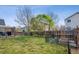 Expansive fenced backyard, a well-maintained lawn and mature trees to create a private retreat at 4422 Mt Shavano St, Brighton, CO 80601