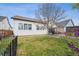 Spacious backyard featuring a stone patio, fenced yard, grass, trees, and great sun exposure at 4422 Mt Shavano St, Brighton, CO 80601