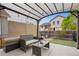 Backyard patio with metal awning, outdoor seating and table for relaxing, dining and entertaining guests at 4422 Mt Shavano St, Brighton, CO 80601