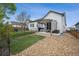 View of the backyard featuring a stone patio, seating, grill and a small patch of artificial turf at 4422 Mt Shavano St, Brighton, CO 80601