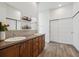 Bathroom featuring double sinks, wood cabinets, and a large mirror at 4422 Mt Shavano St, Brighton, CO 80601