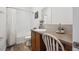 Modern bathroom with white tiling, vanity and drawers, stylish fixtures and a shower-tub combo at 4422 Mt Shavano St, Brighton, CO 80601