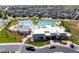 Aerial view of clubhouse with pools and lounge area surrounded by manicured landscaping at 4422 Mt Shavano St, Brighton, CO 80601