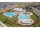 Aerial view showcases a community pool area with multiple pools, lounge chairs, and landscaping at 4422 Mt Shavano St, Brighton, CO 80601