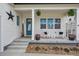 Inviting front porch with rocking chairs, decorative plants, and a welcoming entrance with curb appeal at 4422 Mt Shavano St, Brighton, CO 80601