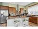 Spacious kitchen with stainless steel appliances, ample wood cabinets, and a center island featuring seating at 4422 Mt Shavano St, Brighton, CO 80601