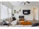 Comfortable living room with stylish decor, a modern fireplace, and bright natural light at 4422 Mt Shavano St, Brighton, CO 80601
