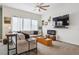 Comfortable living room with plush seating, modern decor, and a ceiling fan at 4422 Mt Shavano St, Brighton, CO 80601