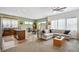 Open-concept living room with a modern kitchen, cozy seating area, and abundant natural light at 4422 Mt Shavano St, Brighton, CO 80601