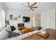 Inviting living room featuring a plush sectional sofa, contemporary decor, and a modern ceiling fan at 4422 Mt Shavano St, Brighton, CO 80601