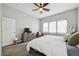 Bright main bedroom features neutral color palette, soft carpet, ceiling fan, and view of large windows at 4422 Mt Shavano St, Brighton, CO 80601