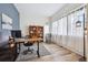 Bright home office featuring a large desk, shelving, wood floors, and lots of natural light at 4422 Mt Shavano St, Brighton, CO 80601