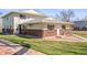 Charming exterior of a brick and siding home, featuring a small patio and well-maintained lawn at 7309 W Hampden Ave # 601, Lakewood, CO 80227