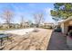 Community pool area with lounge chairs, picnic tables, and surrounding trees for shade and privacy at 7309 W Hampden Ave # 601, Lakewood, CO 80227
