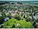Scenic aerial view highlighting the neighborhood's proximity to a park with playground, mature trees, and walking trails at 12651 E Bates Cir, Aurora, CO 80014