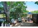 Secluded backyard featuring comfortable seating, mature trees, and lush landscaping for outdoor enjoyment at 12651 E Bates Cir, Aurora, CO 80014