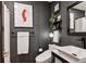 Bathroom featuring a unique painting on the wall, decorative mirror, and wall shelves at 12651 E Bates Cir, Aurora, CO 80014
