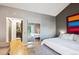 Bedroom featuring a bed, closet with mirror doors, and a view of the bathroom at 12651 E Bates Cir, Aurora, CO 80014