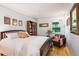 Cozy bedroom with a queen-size bed and unique artwork at 12651 E Bates Cir, Aurora, CO 80014