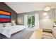 Bright bedroom with sliding glass doors leading to an outdoor area, with modern lighting at 12651 E Bates Cir, Aurora, CO 80014