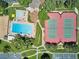 Top-down view showcasing the community pool, tennis courts, and recreational facilities, surrounded by landscaped grounds at 12651 E Bates Cir, Aurora, CO 80014