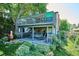 Outdoor deck with lounge chairs, upper level deck with signage, and landscaped yard create a relaxing retreat at 12651 E Bates Cir, Aurora, CO 80014