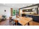 Open dining area with a view into the updated kitchen, featuring wood countertops at 12651 E Bates Cir, Aurora, CO 80014