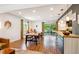 Bright dining area featuring hardwood floors, modern lighting, and a sliding glass door to the outdoor deck at 12651 E Bates Cir, Aurora, CO 80014