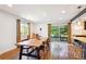 Dining room with a large wood table, views to the deck and backyard, and modern lighting at 12651 E Bates Cir, Aurora, CO 80014