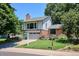 Charming two-story home featuring a brick facade, lush landscaping, and a well-maintained lawn at 12651 E Bates Cir, Aurora, CO 80014