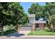 Charming two-story home featuring a brick facade, lush landscaping, and a well-maintained lawn at 12651 E Bates Cir, Aurora, CO 80014