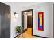 Stylish foyer featuring modern lighting, artistic decor, and a glimpse into the home's interior at 12651 E Bates Cir, Aurora, CO 80014