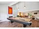 Spacious game room featuring a pool table, modern lighting, and an open layout perfect for entertaining at 12651 E Bates Cir, Aurora, CO 80014