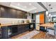 Bright, updated kitchen features stainless appliances, a breakfast bar, and hardwood floors at 12651 E Bates Cir, Aurora, CO 80014
