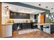 Updated kitchen featuring stainless steel appliances, dark cabinetry, and modern lighting at 12651 E Bates Cir, Aurora, CO 80014