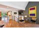 Bright living room with sleek flooring, contemporary furniture, and an open layout to the dining area at 12651 E Bates Cir, Aurora, CO 80014