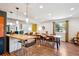 Open-concept layout with dining and living areas, hardwood floors, and modern decor at 12651 E Bates Cir, Aurora, CO 80014